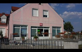 Rosa Gebäude mit Café und Terrasse, blauer Himmel im Hintergrund., © Donau Niederösterreich